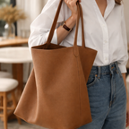 Person holding a brown tote bag in an indoor setting