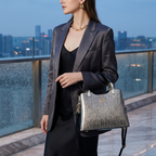 Woman in a dark suit holding a handbag with a cityscape background